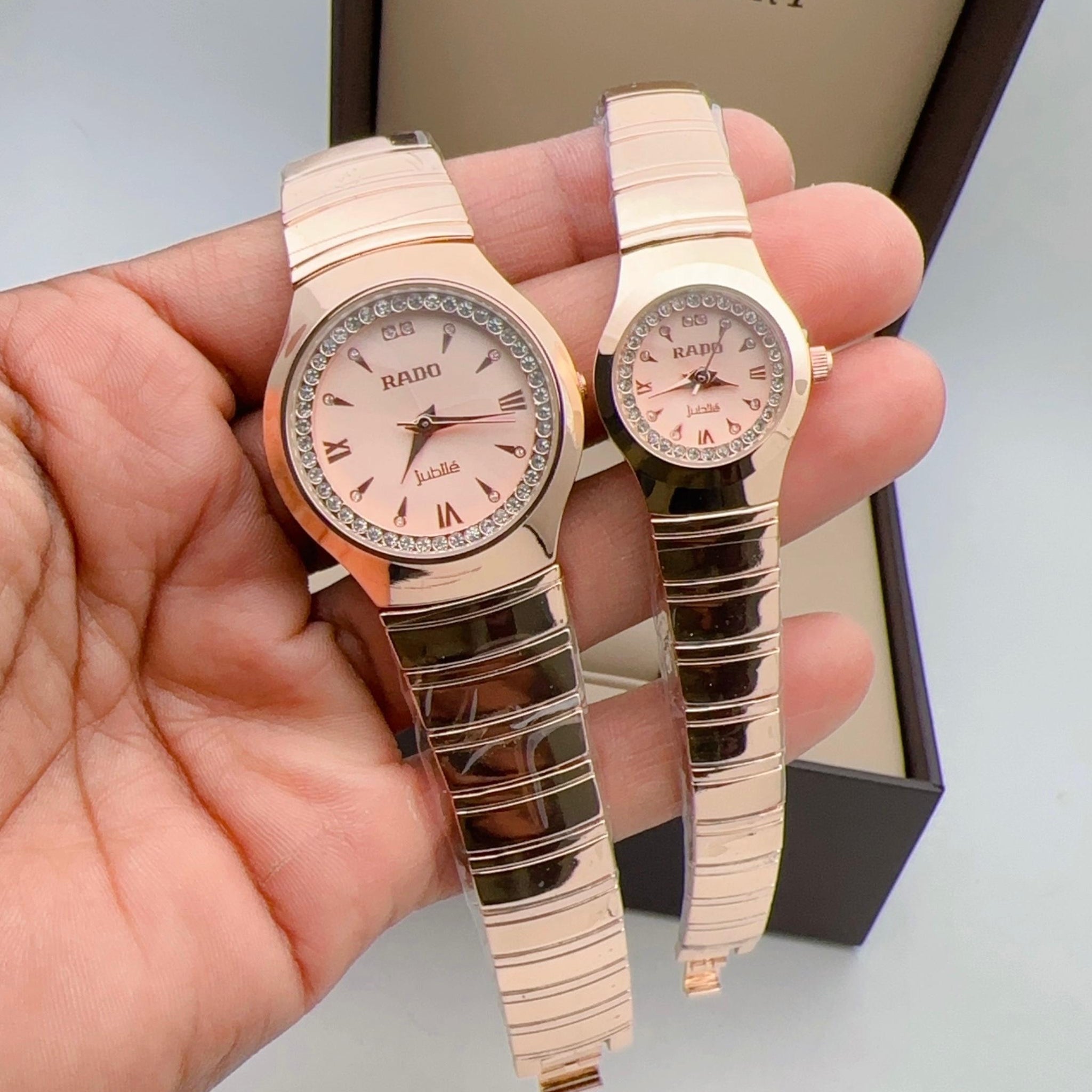Rado watches, both with a rose gold finish and pink dials.